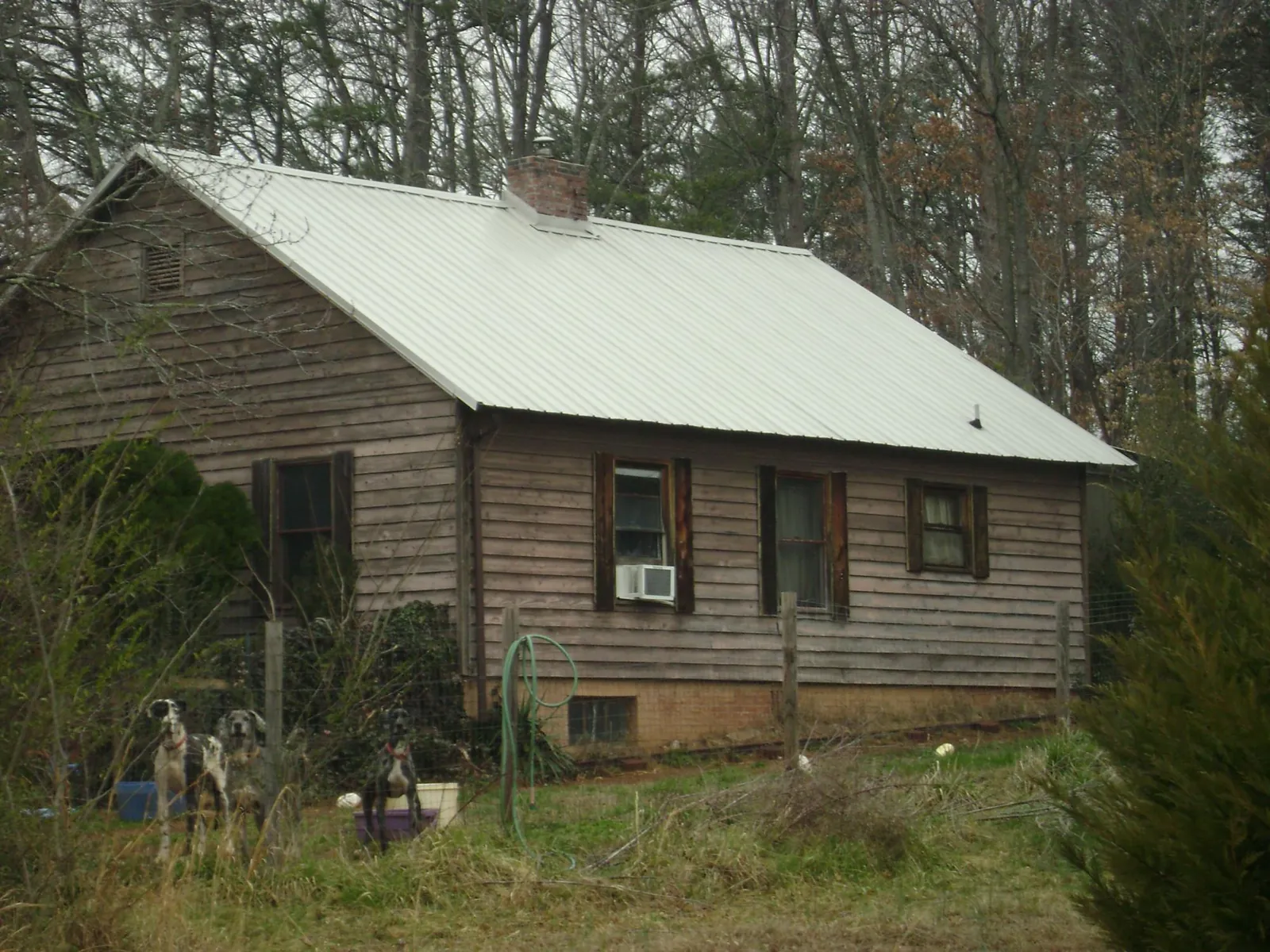 White metal roof on an old wood sided farmhouse, from a Metal Roof Installation job in Porter